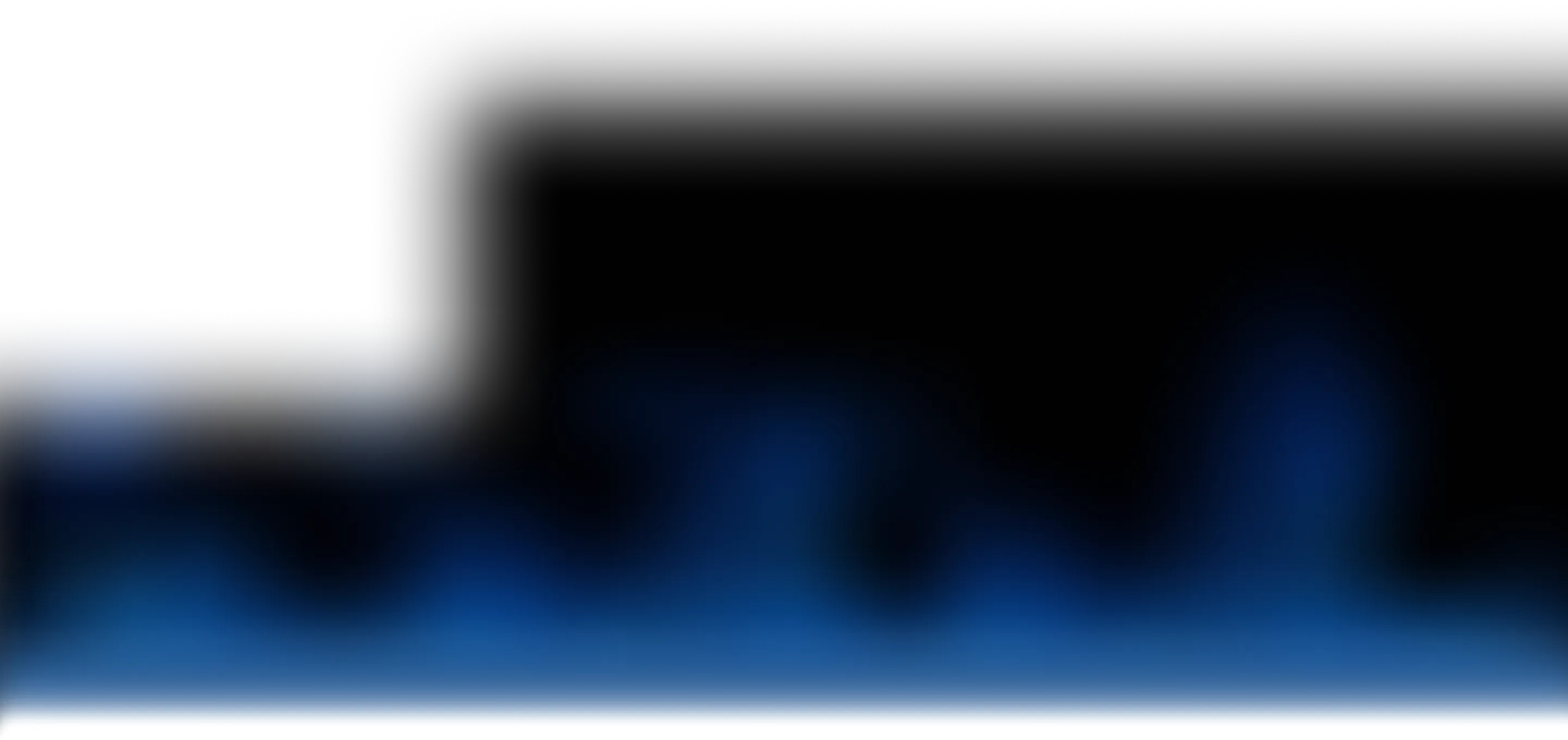 Blurred blue lights fading into black background, abstract glow effect.