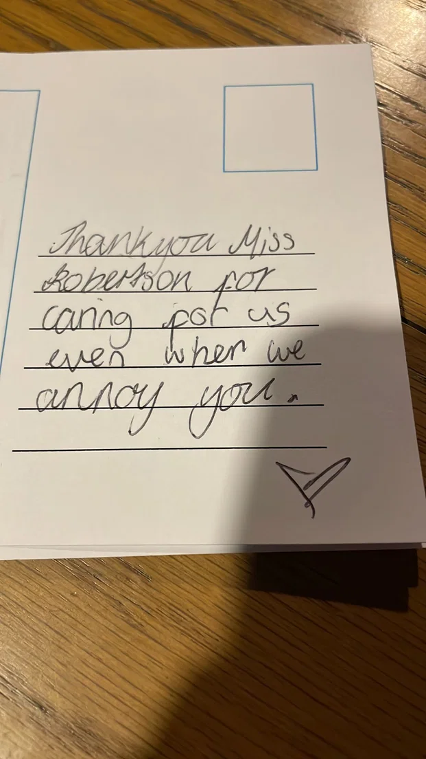 Handwritten postcard to Miss Robertson reading 'Thank you for caring for us even when we annoy you.'