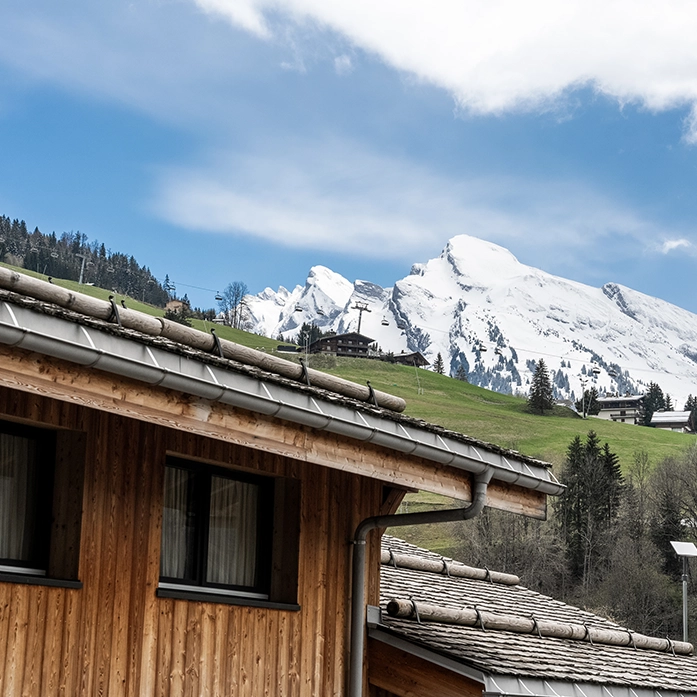 Facade of St-Alban with the snowy mountain in the background