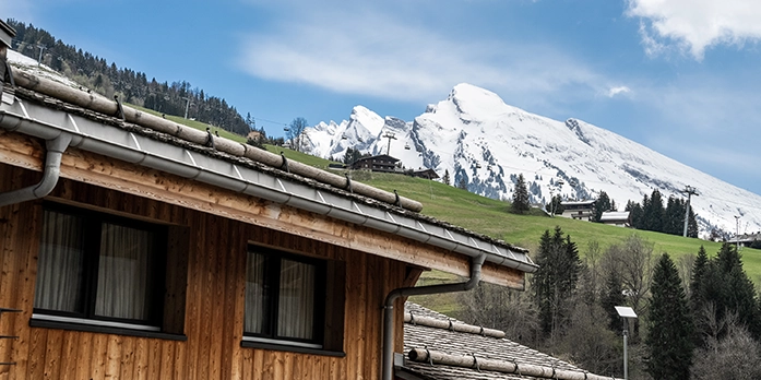 Facade of St-Alban with the snowy mountain in the background