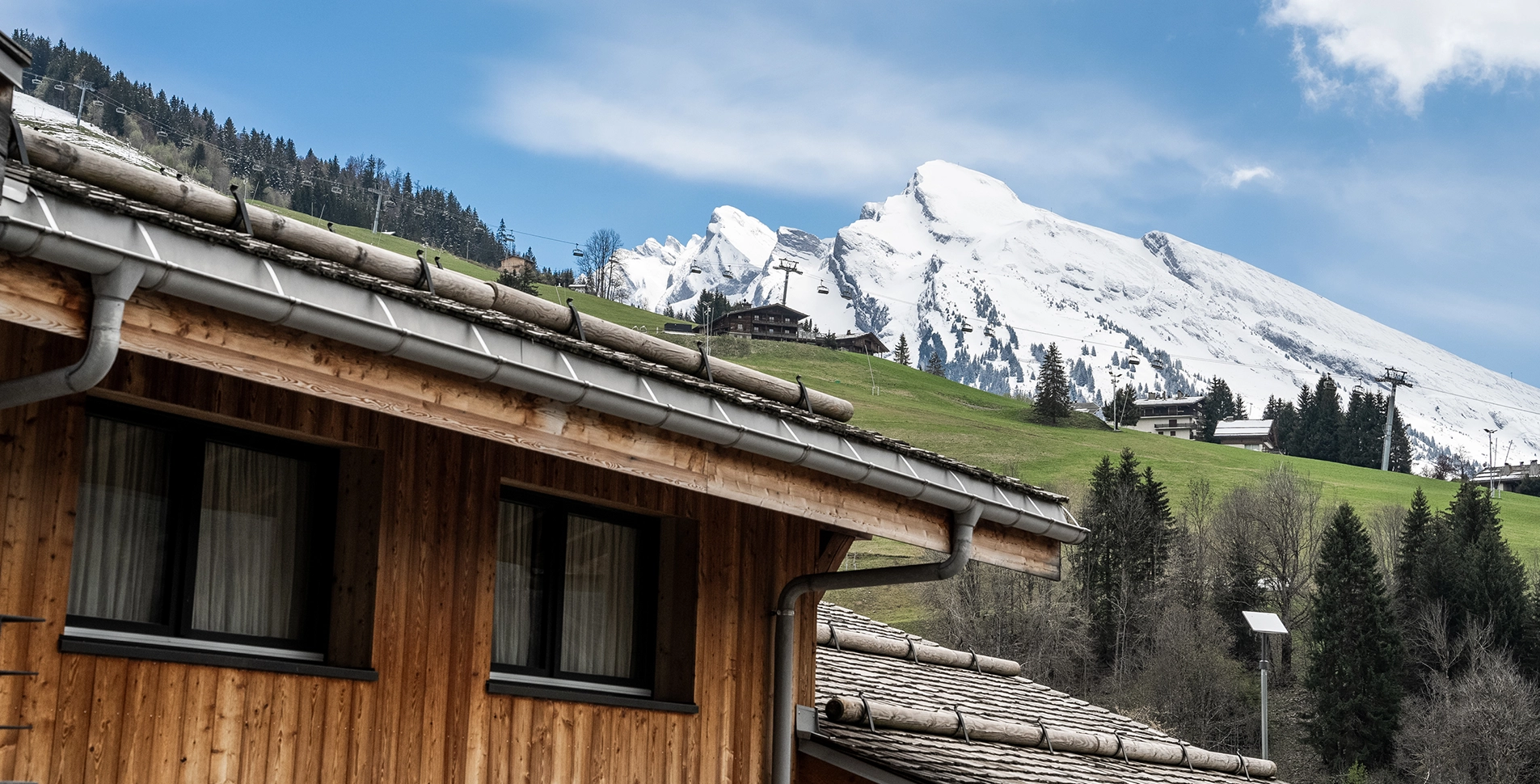 Facade of St-Alban with the snowy mountain in the background