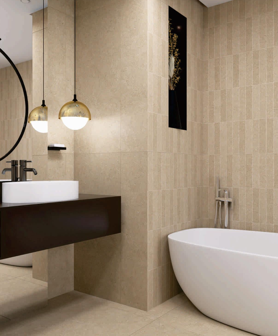 The bathroom walls feature vertically stacked slim rectangular tiles in a textured beige finish alongside larger format stone tiles in a matching neutral tone.