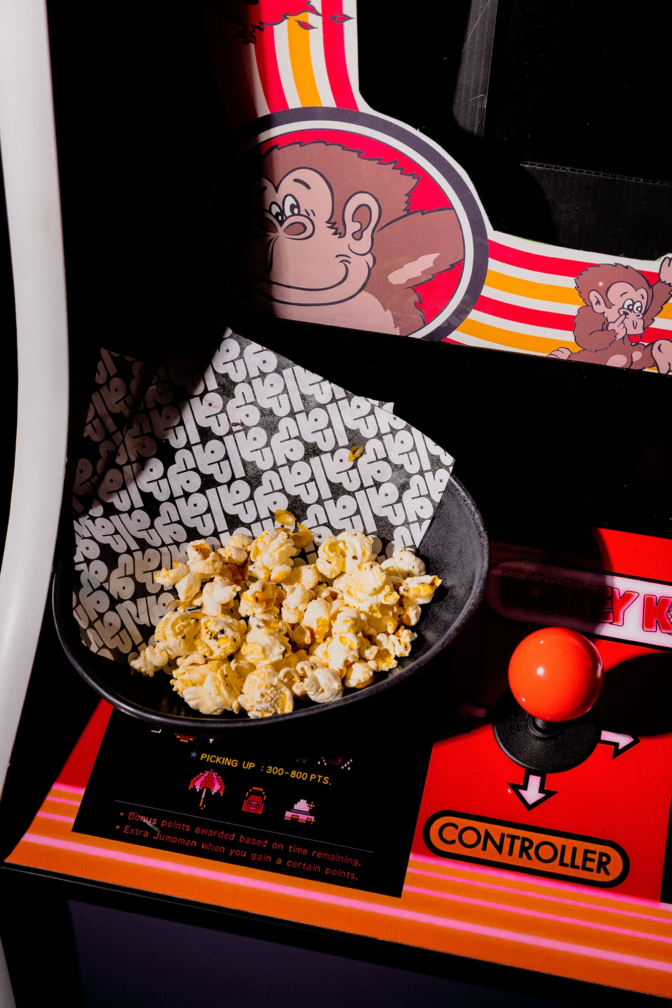 Gala Gala branded popcorn box and arcade joystick controller
