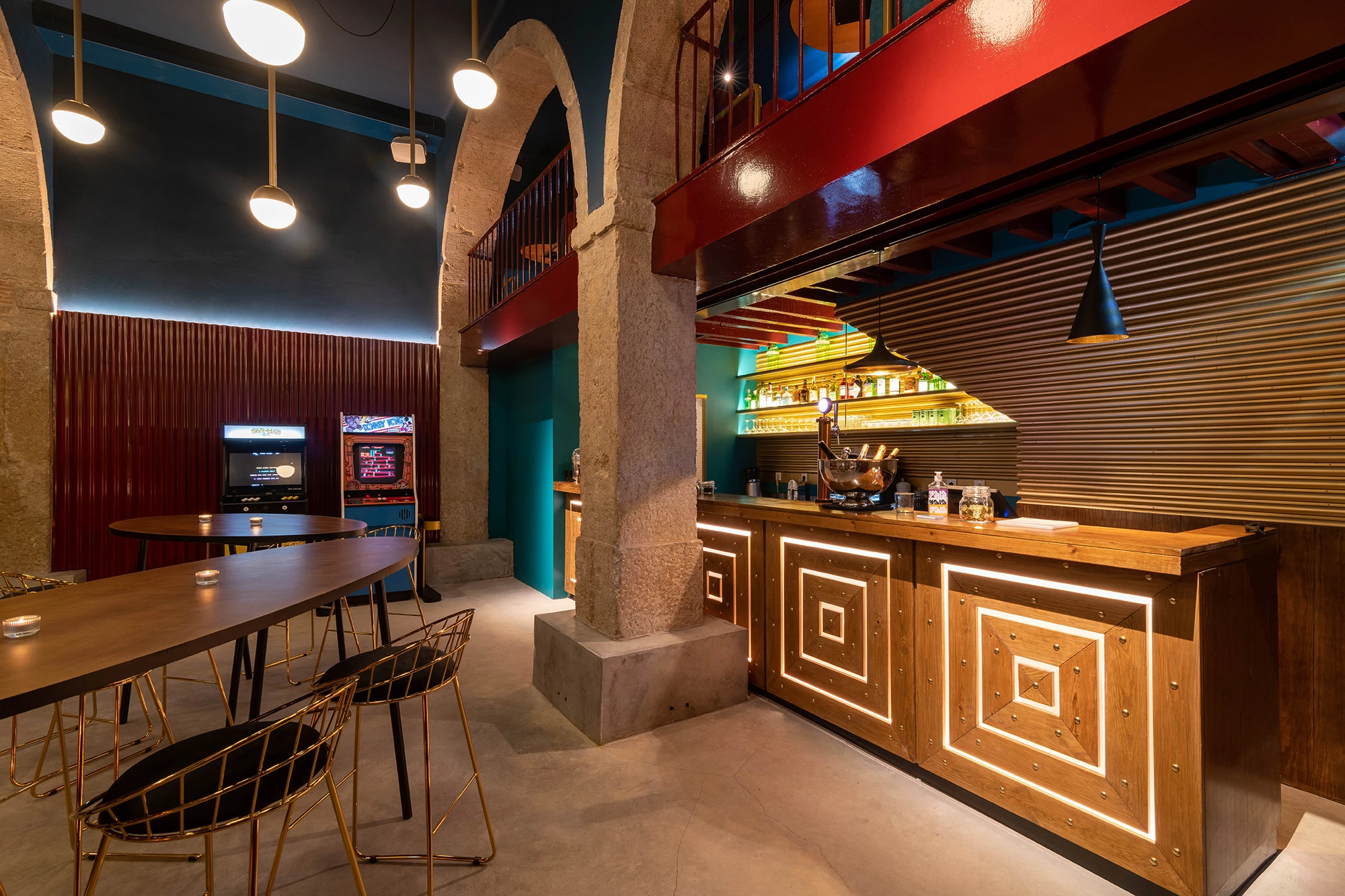 Gala Gala bar interior with arched stone ceiling, colourful lighting and bar counter in Lisbon

