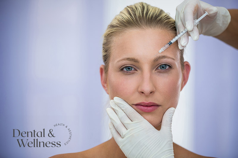 Gloved practitioner injecting a woman's forehead — anti-wrinkle treatment myths