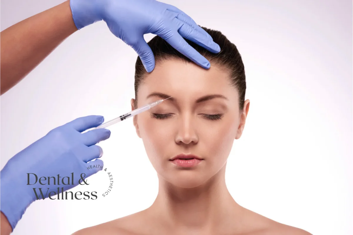 Forehead anti-wrinkle treatment: gloved clinician injecting into a woman's forehead during an anti-wrinkle treatment