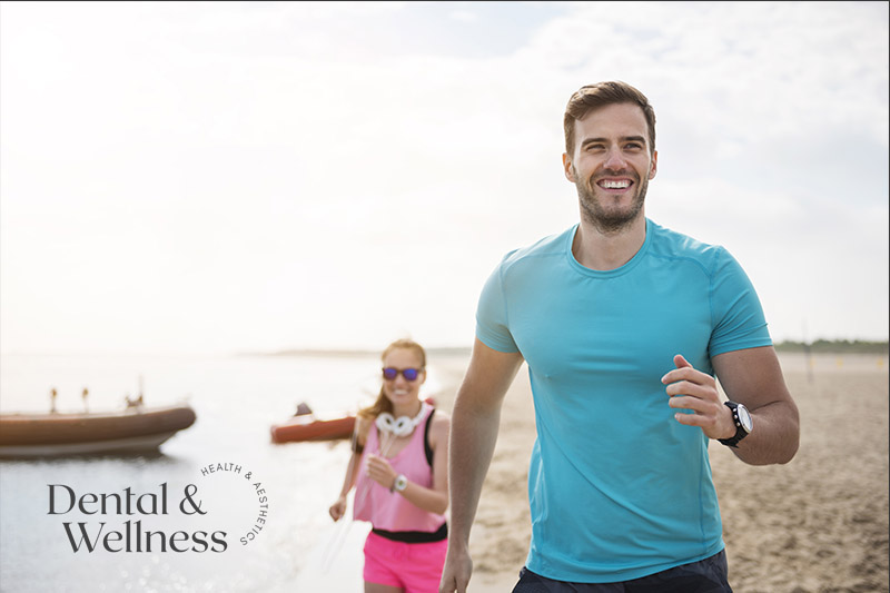 Man and woman jogging along a beach