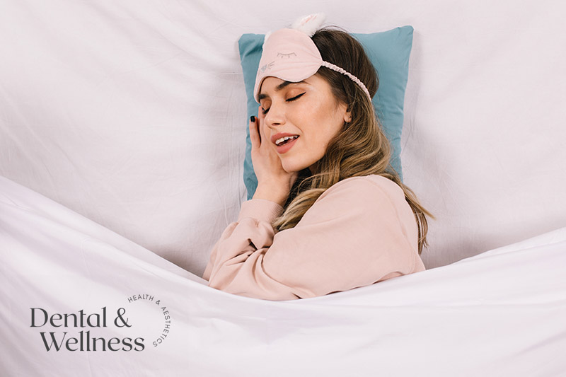 Woman sleeping peacefully with a sleep mask on her forehead