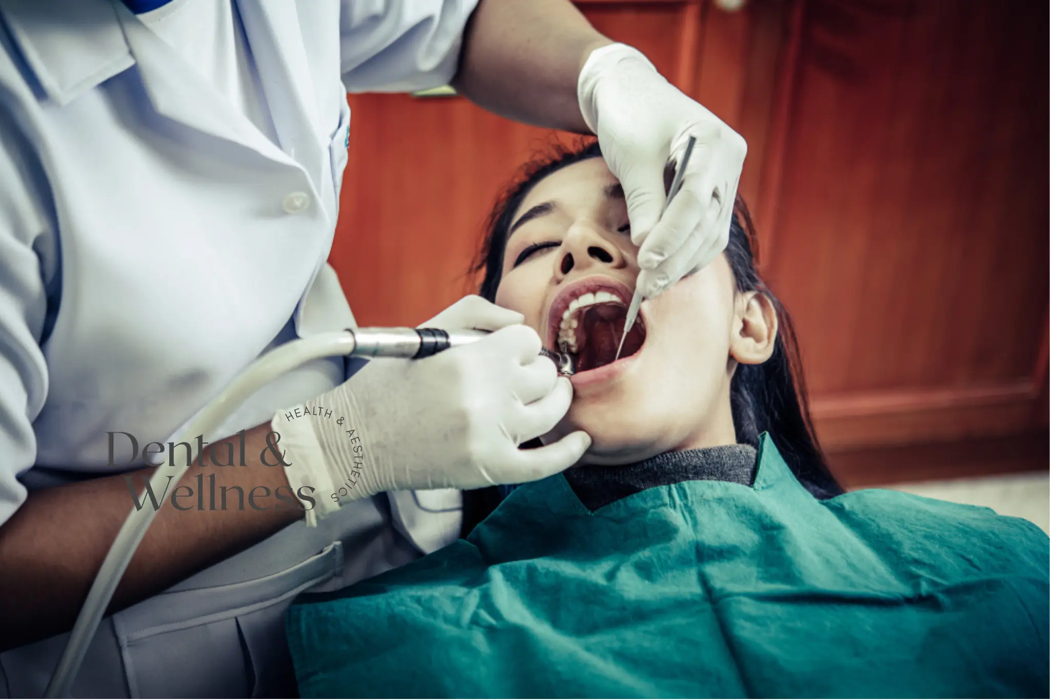 Dentist treating a patient's teeth with a handpiece and mirror — root canal treatment time