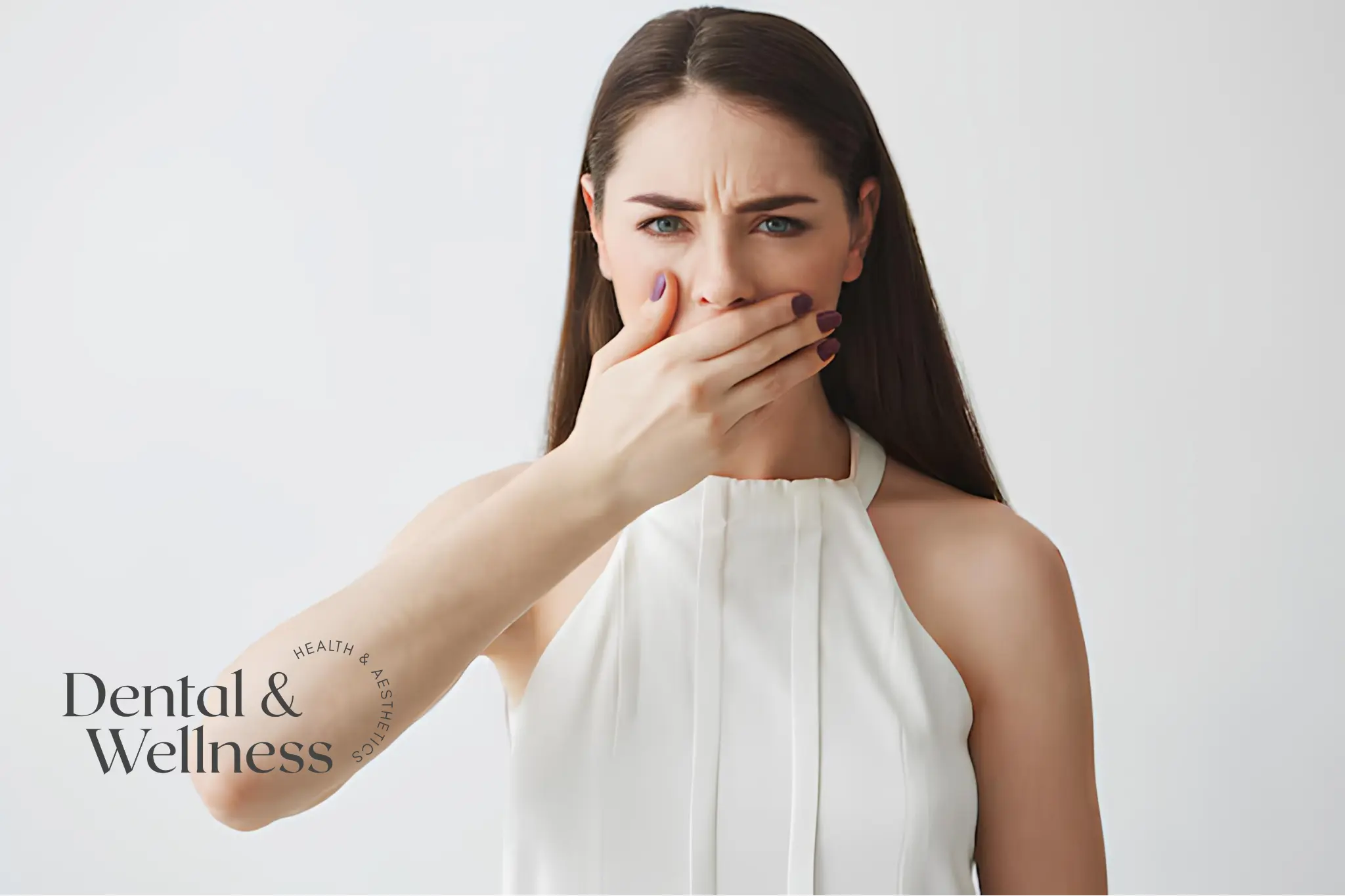 Bad breath treatment: woman covering her mouth with her hand, concerned about her breath