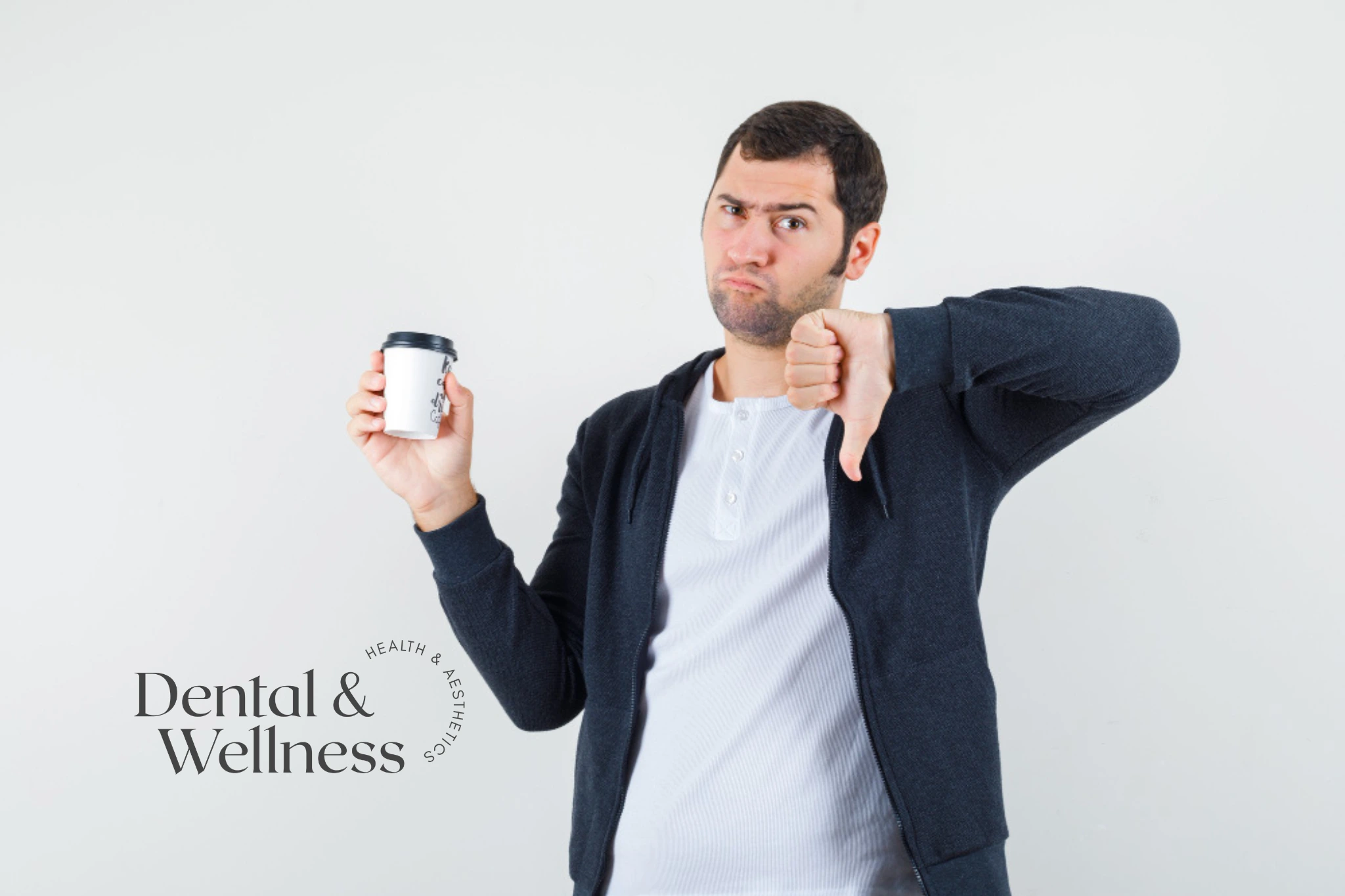 Man holding a coffee cup and giving a thumbs down — laser teeth whitening