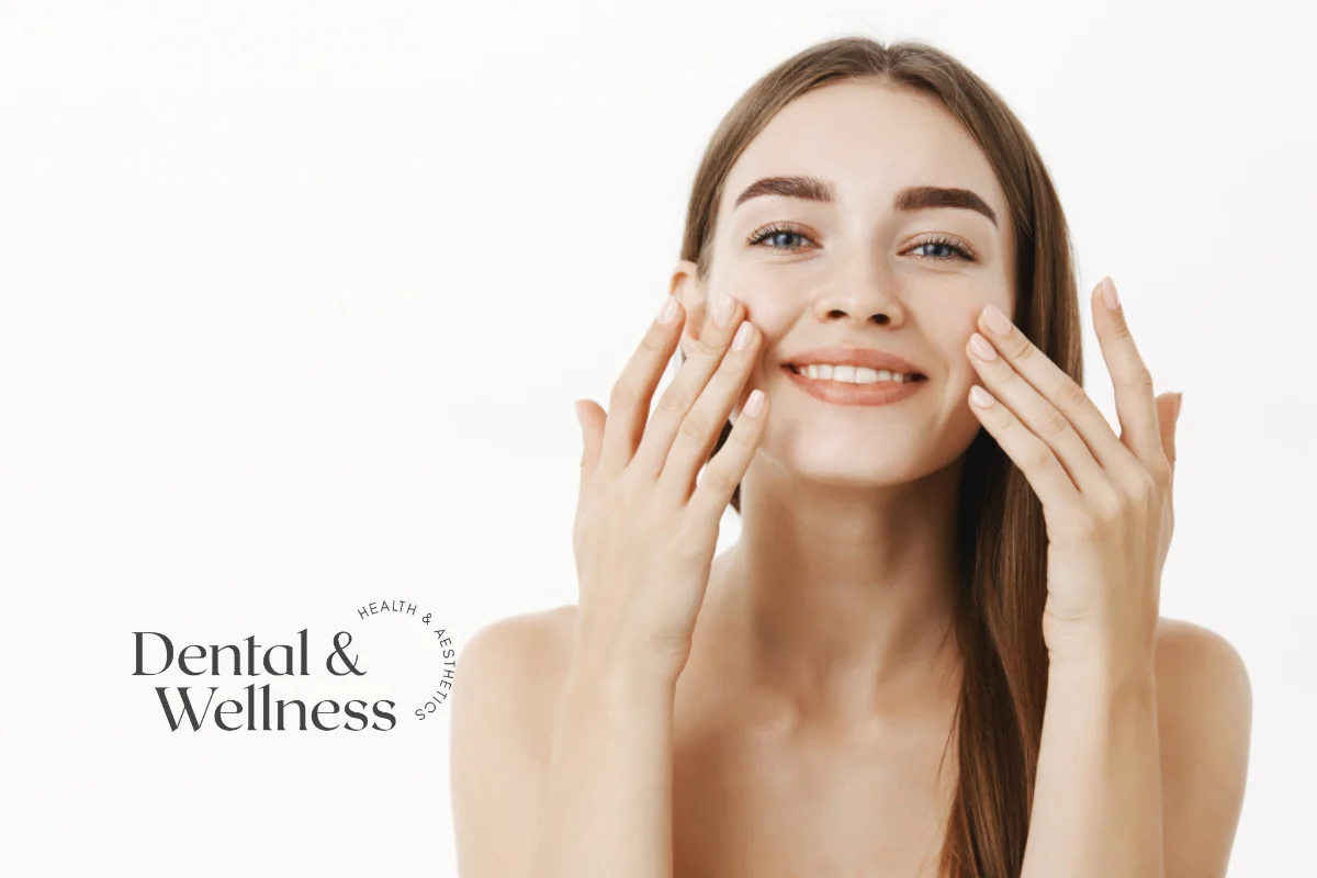 Skin care routine by age: smiling woman touching her cheeks with her fingertips