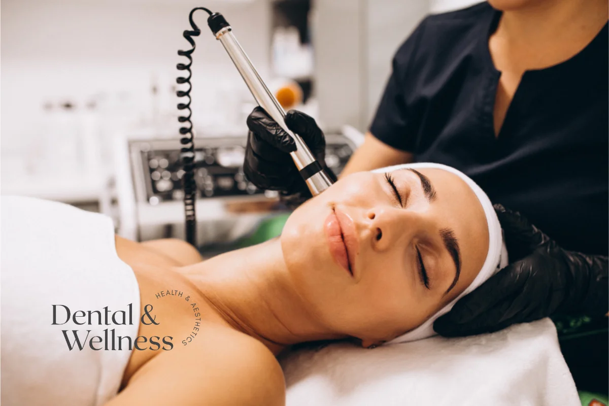 Therapist using a skin treatment device on a relaxed client's face