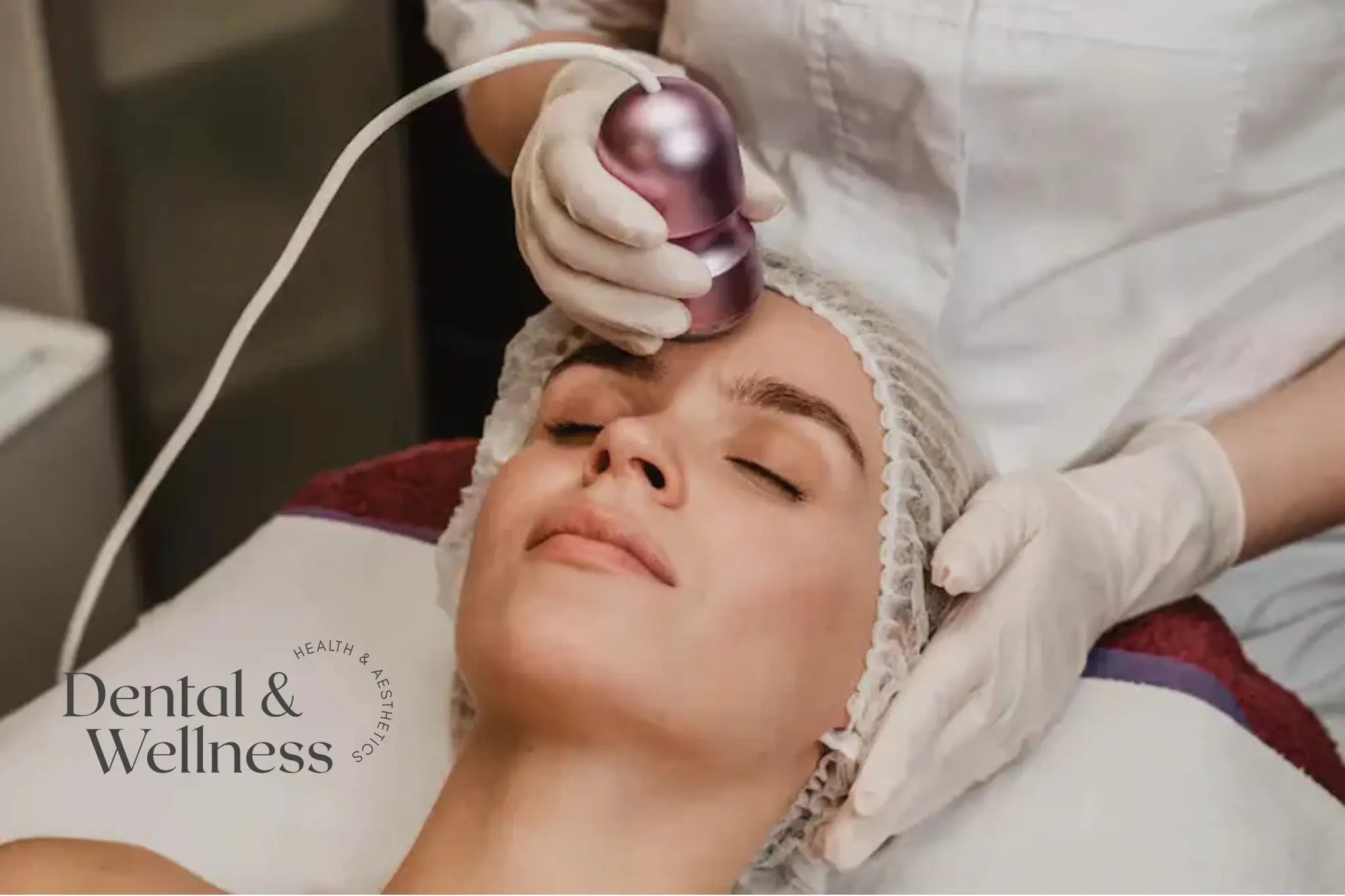 Jowls: woman lying back during a facial treatment with a handheld device on her forehead