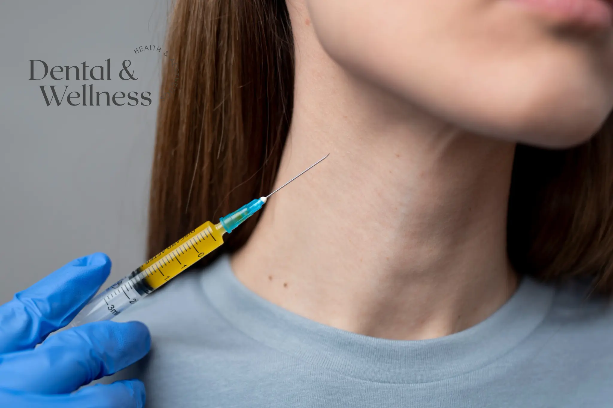 Gloved hand holding a syringe beside a woman's neck and jawline — jowls