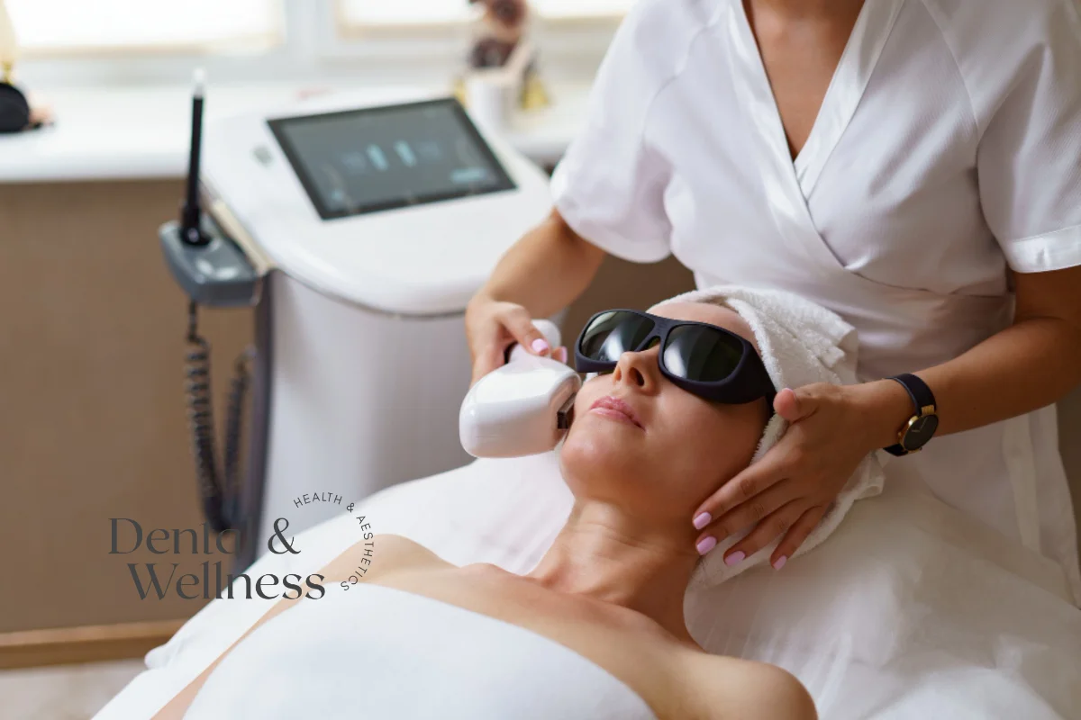 Therapist carrying out a skin-tightening treatment on a woman's face