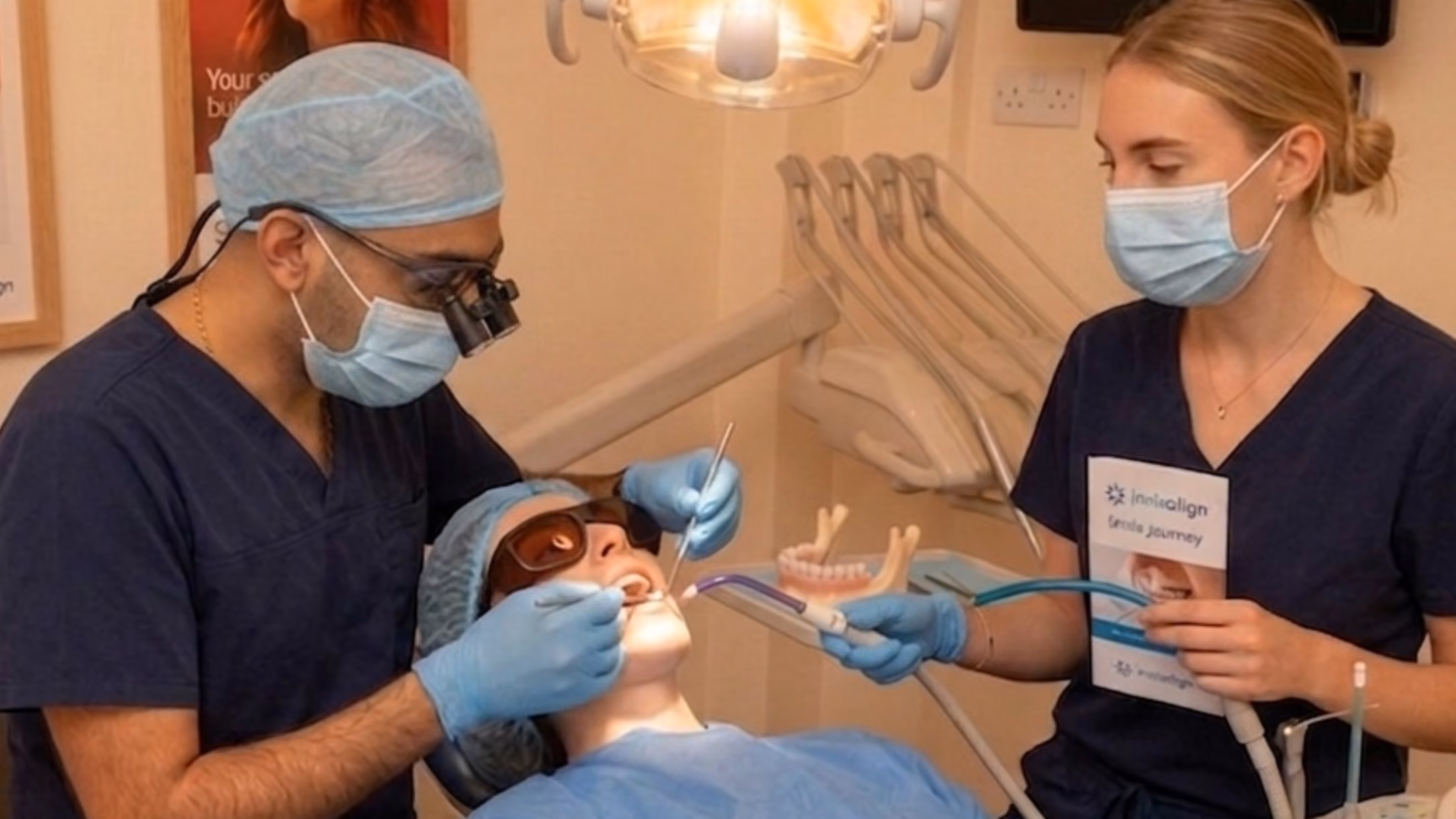 Smile makeover in Islington, London: dentist and dental nurse treating a patient in the chair during smile makeover treatment