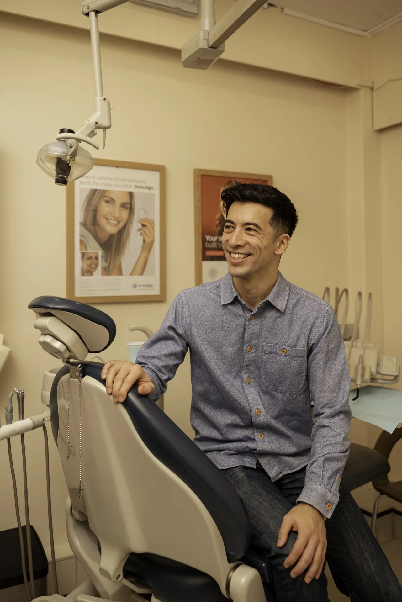 Smiling patient seated in the dental chair in a treatment room