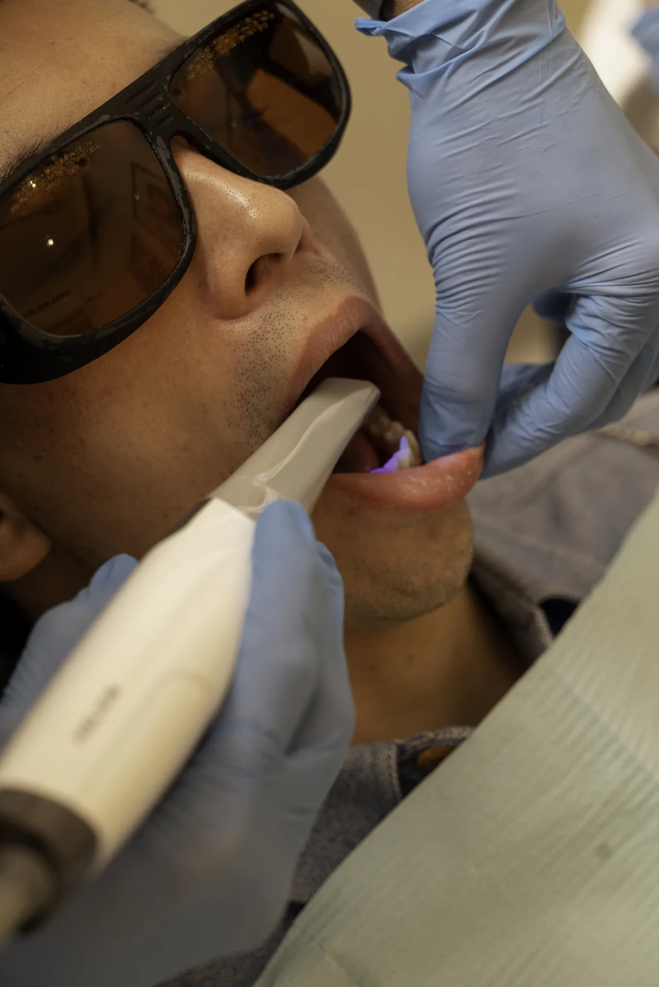 Patient in protective glasses having an intraoral scan — dental implants