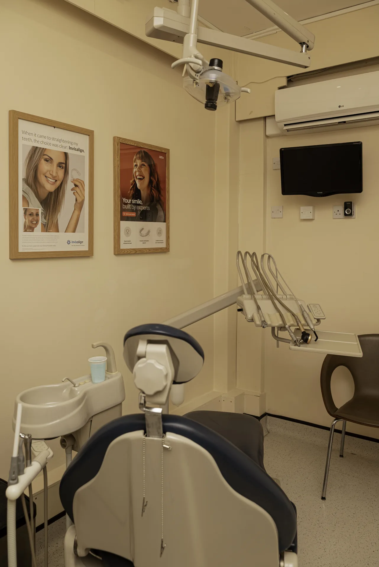 Treatment room with the dental chair and wall posters