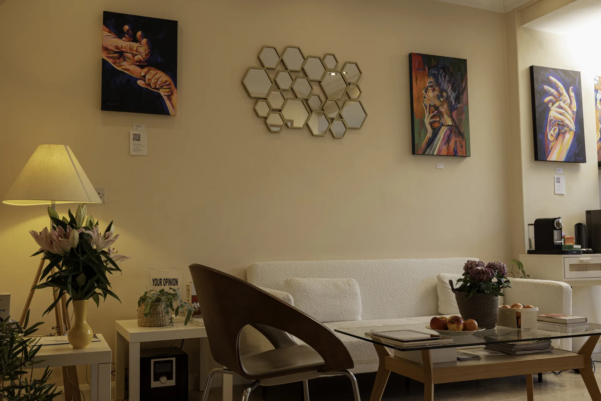 Waiting lounge at Dental & Wellness London with a sofa, lamps and artwork — dentist for Holloway