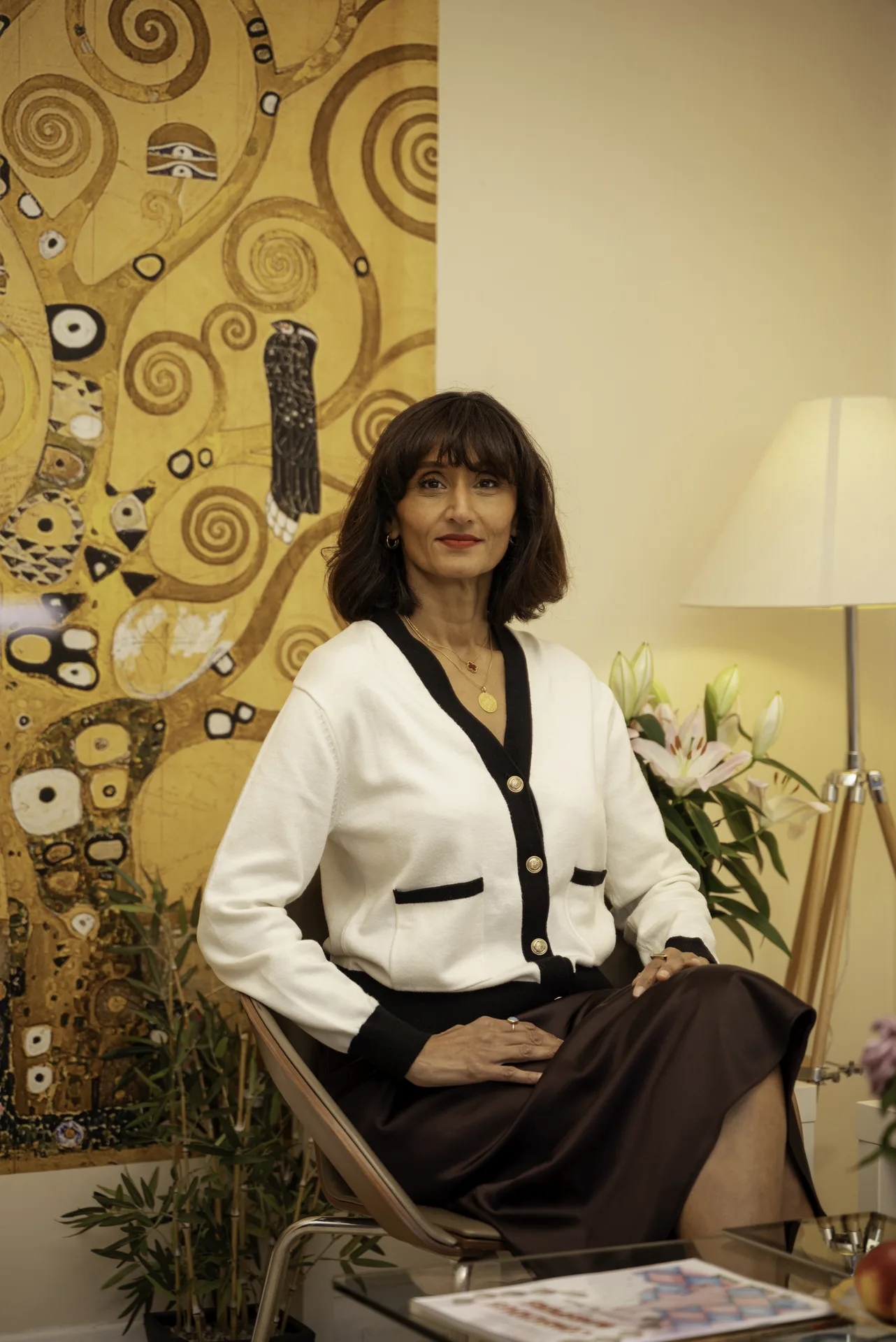 Wellness practitioner seated in the clinic lounge — body psychotherapy