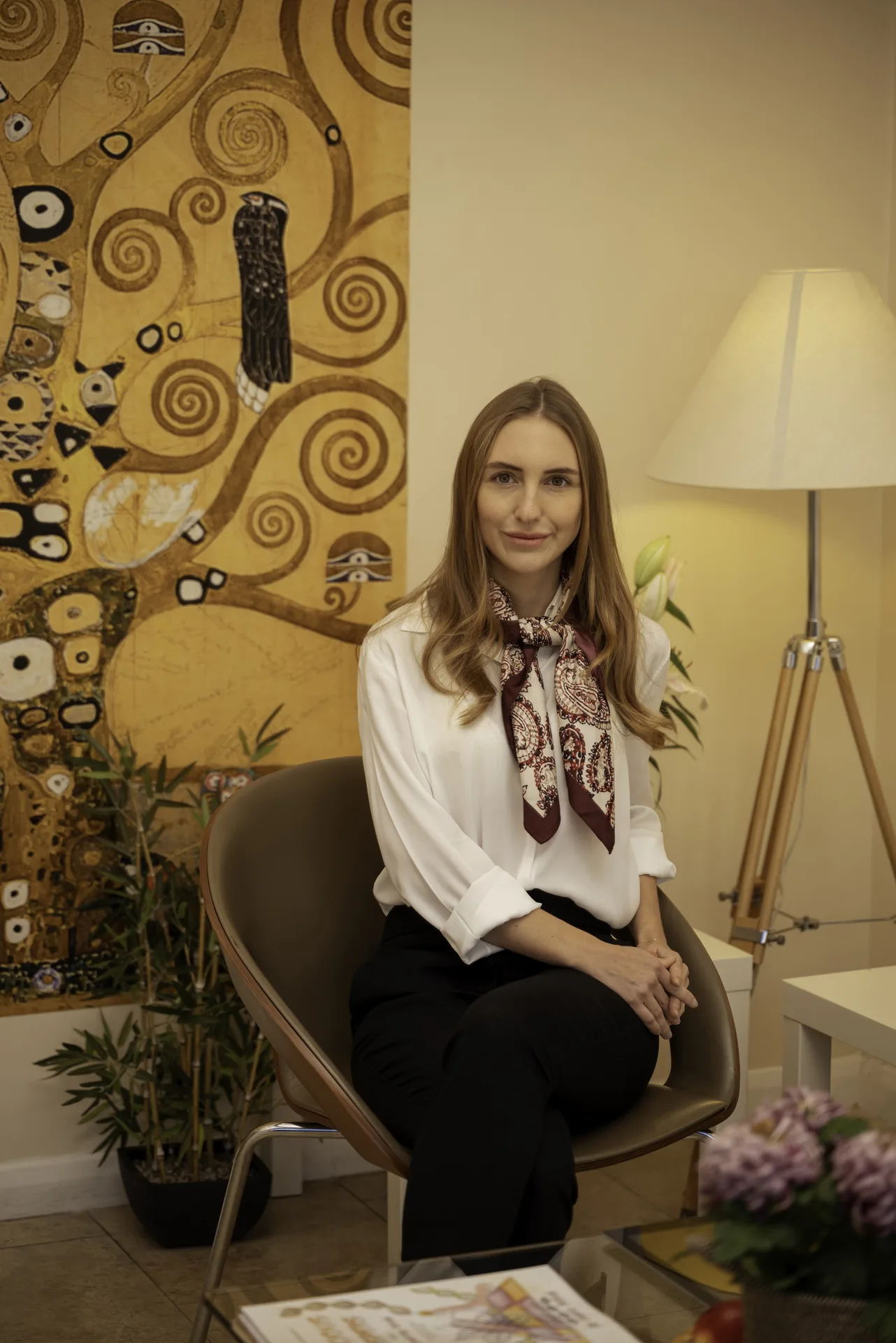Wellness practitioner seated in the clinic lounge — functional medicine