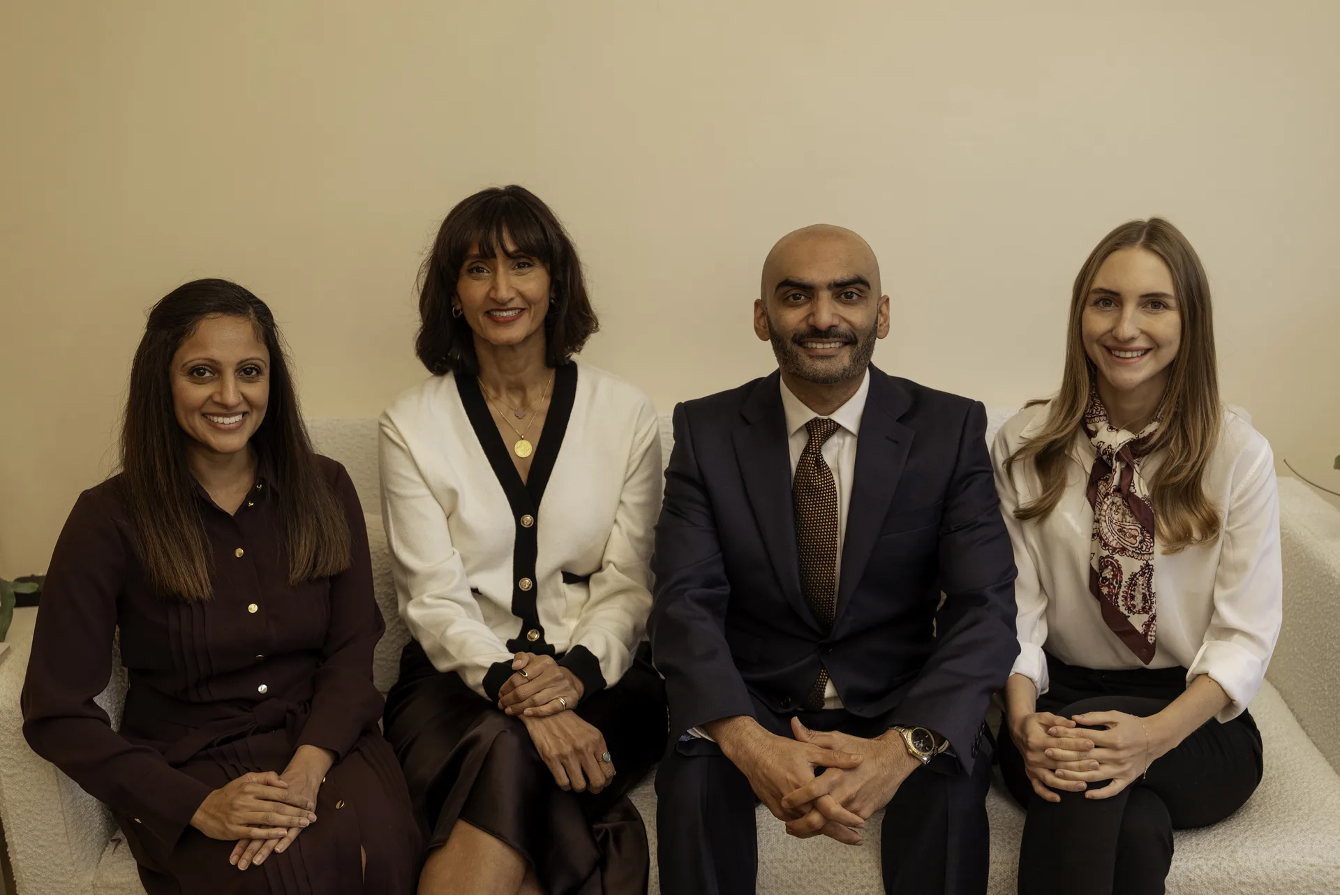 The Dental & Wellness London team seated together in the clinic lounge — private dentist vs NHS
