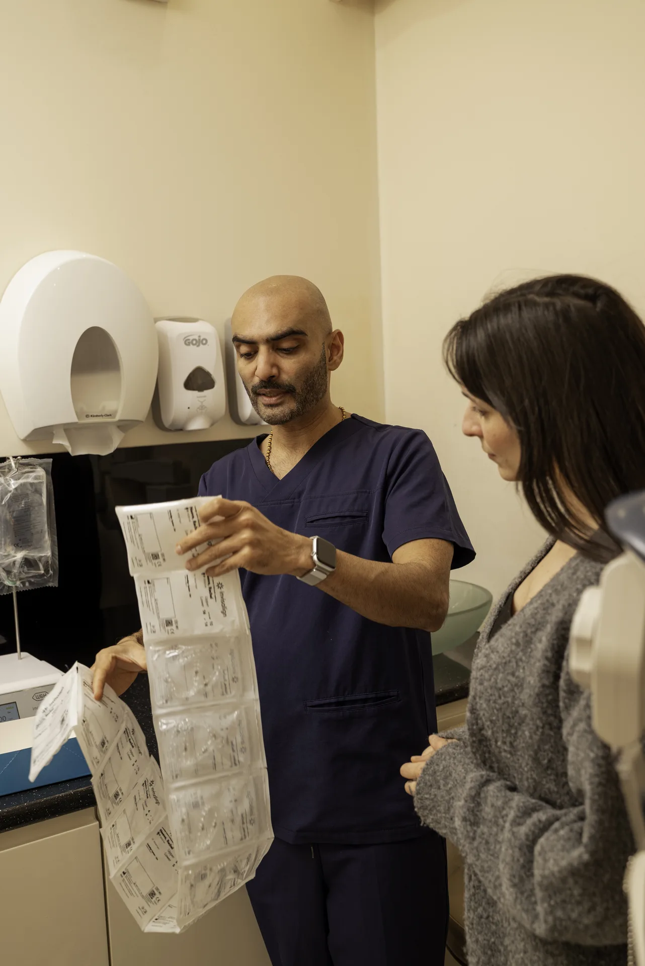 Dentist showing a patient her aligner treatment paperwork in the surgery — Invisalign effectiveness