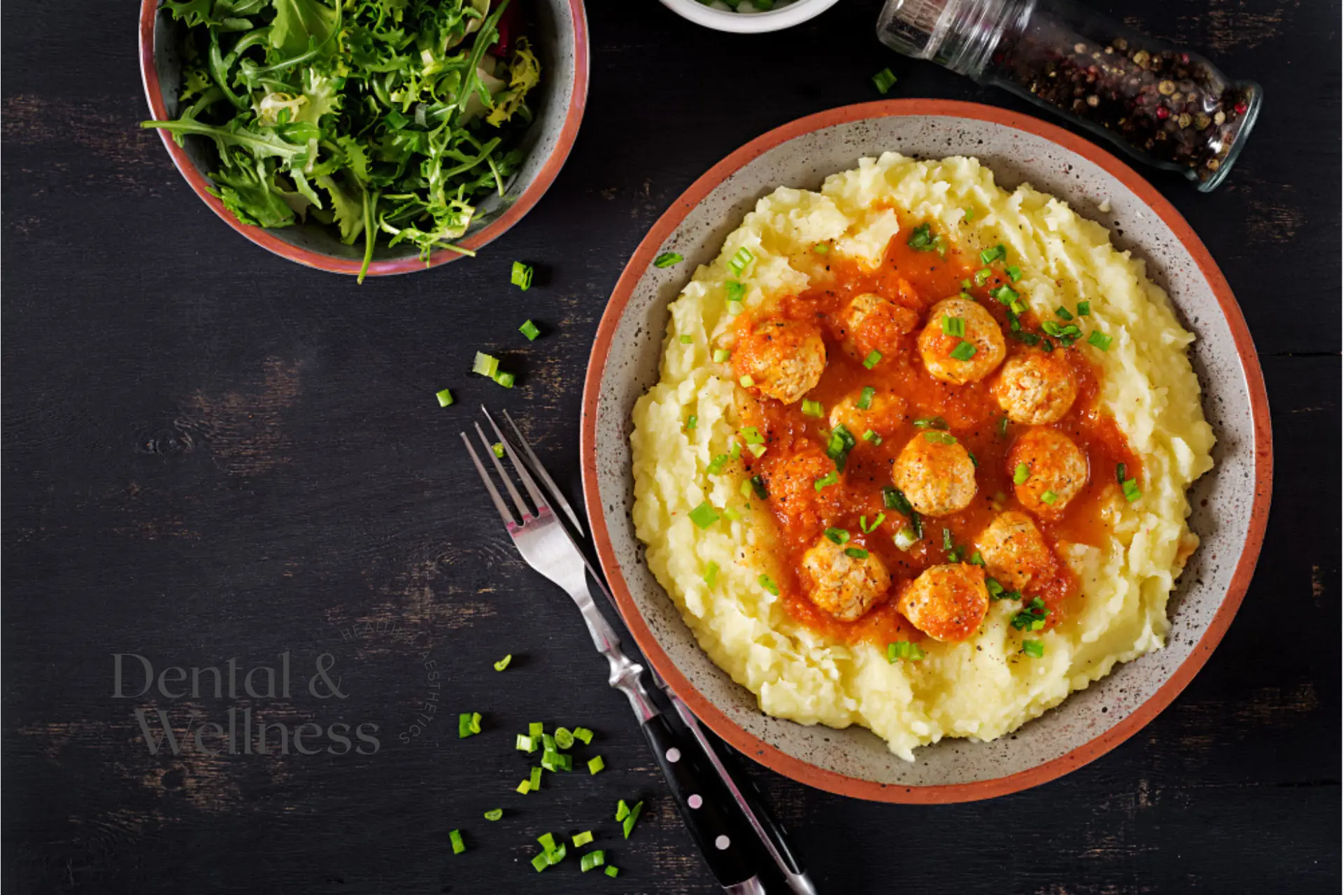 Bowl of mashed potato topped with meatballs in tomato sauce, a soft-food option after an extraction
