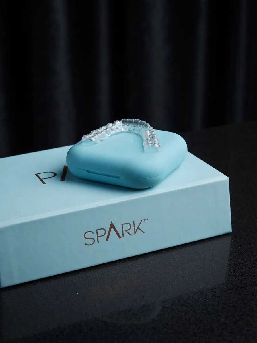 Spark aligners in Islington, London: Spark clear aligner and case resting on the Spark box