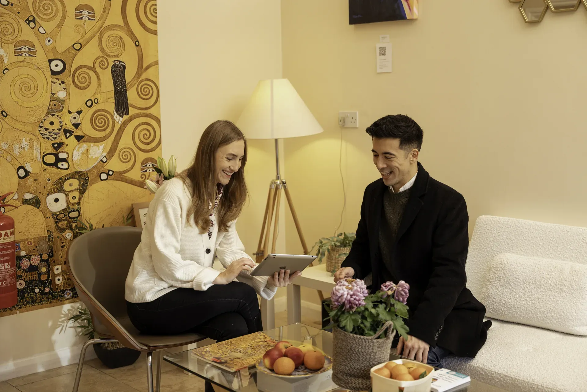 Practitioner and client talking over a tablet in the clinic lounge — panic attack support