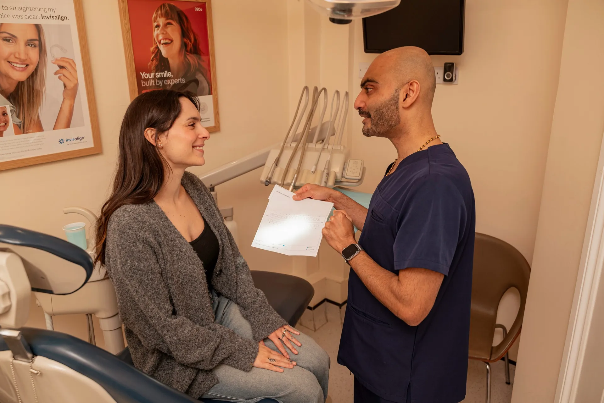 Dentist going through a treatment plan with a patient seated in the dental chair