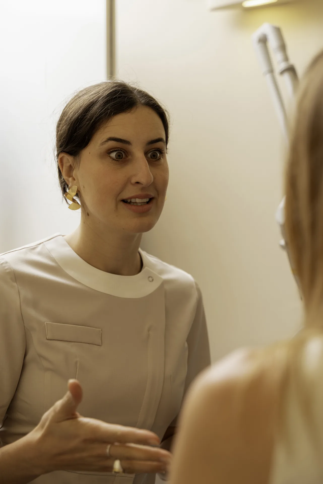 Microneedling in Islington, London: therapist explaining a treatment to a patient