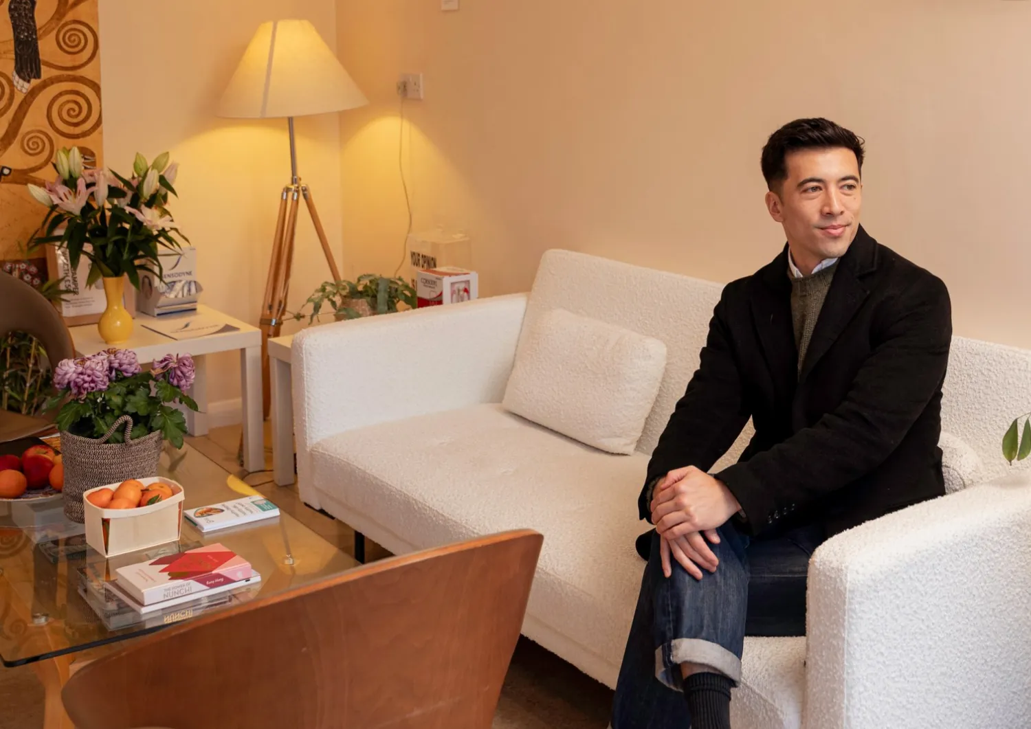 Patient waiting on a sofa in the clinic lounge — family dentist