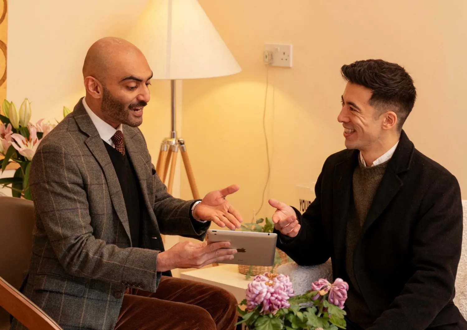 Clinician and patient talking over a tablet in the clinic lounge