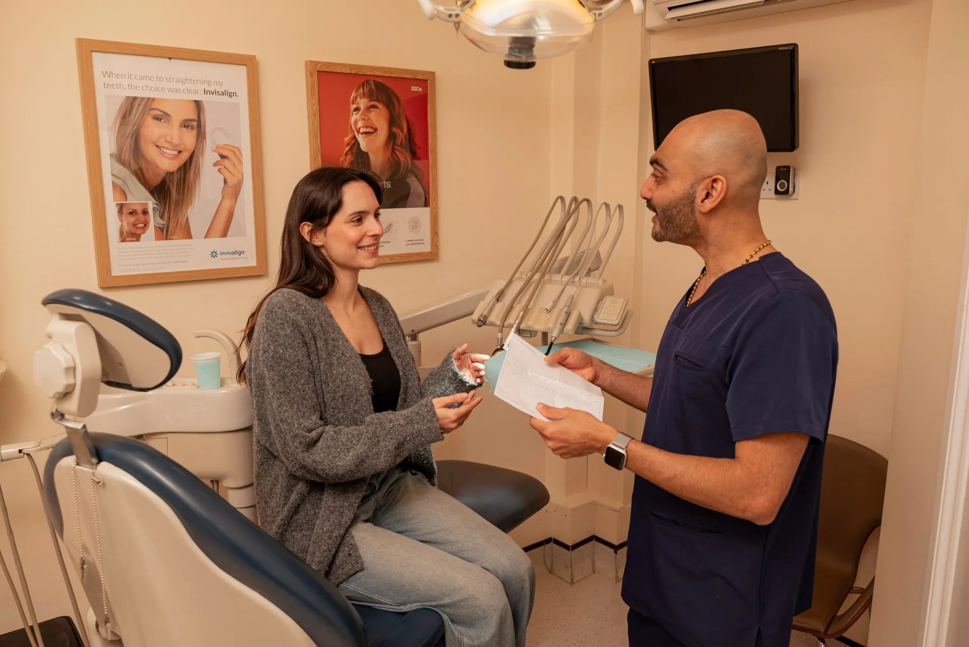 Dentist going through a treatment plan with a patient seated in the dental chair