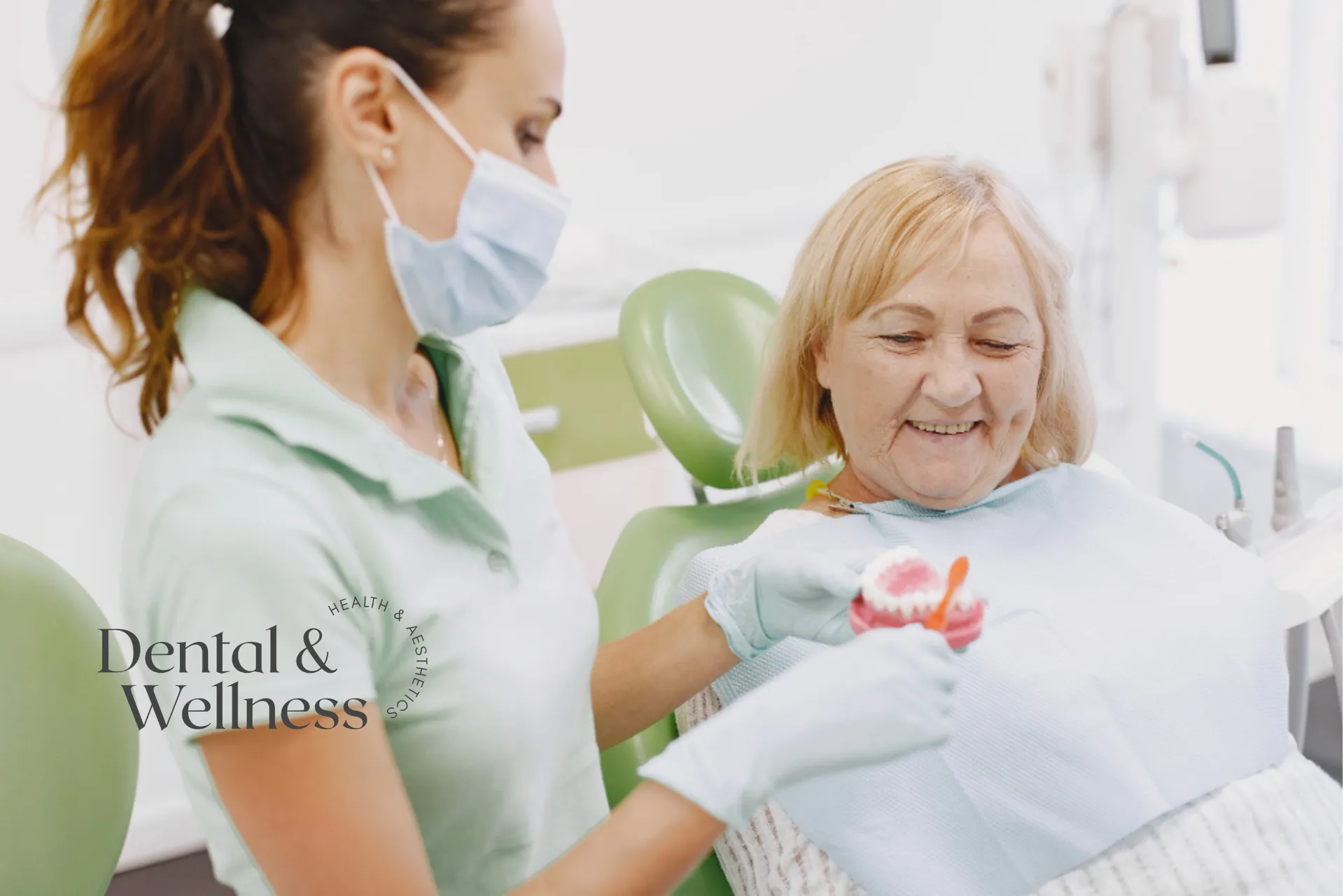 Smiling older patient being shown a denture by a dental nurse — full mouth dental implants