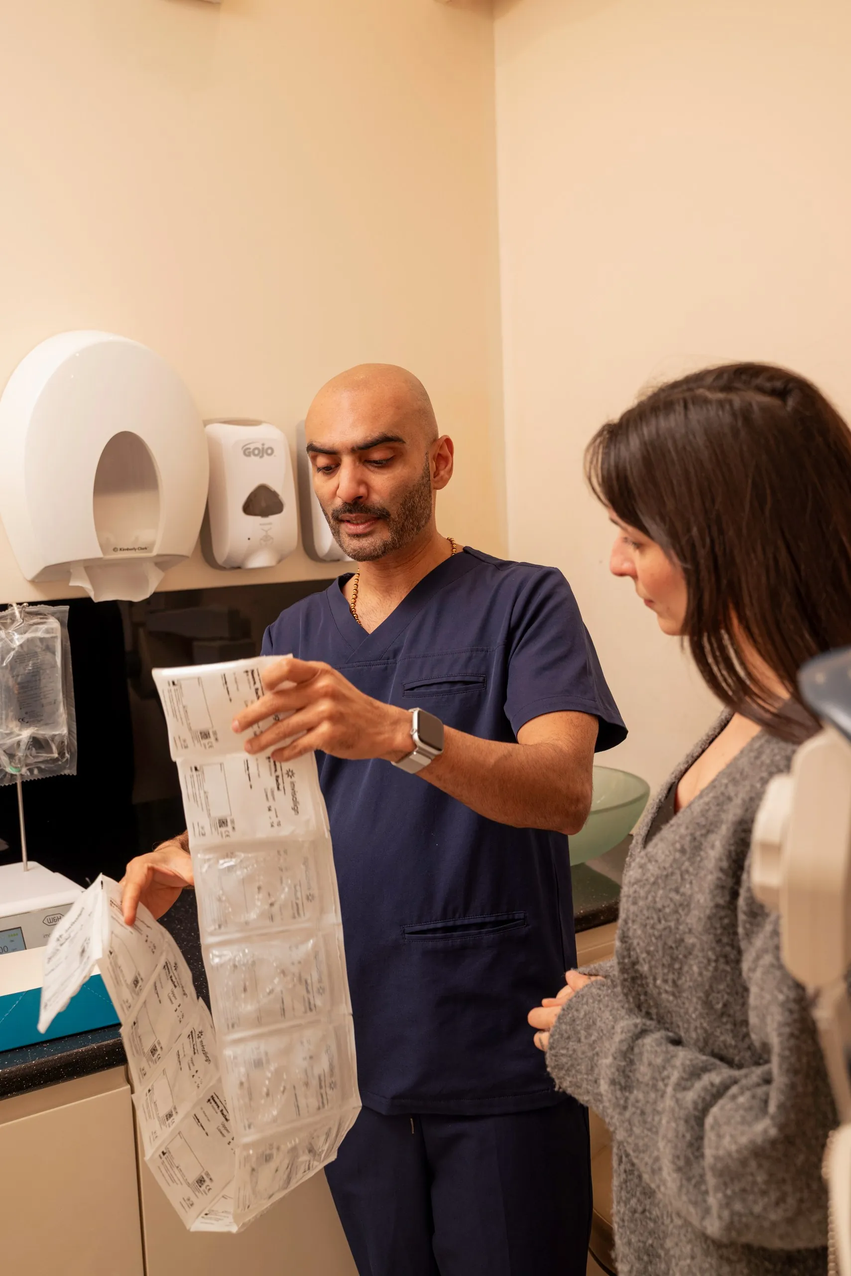 Invisalign pain: dentist showing a patient her aligner paperwork in the surgery