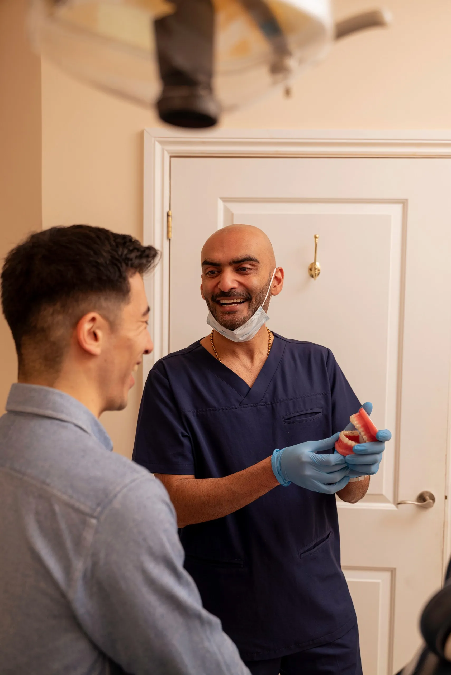 Dentist chatting with a patient in the treatment room