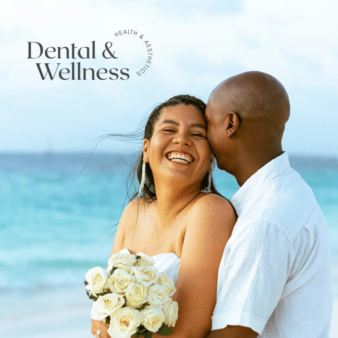 Bride and groom laughing together on a beach — gummy smile treatment