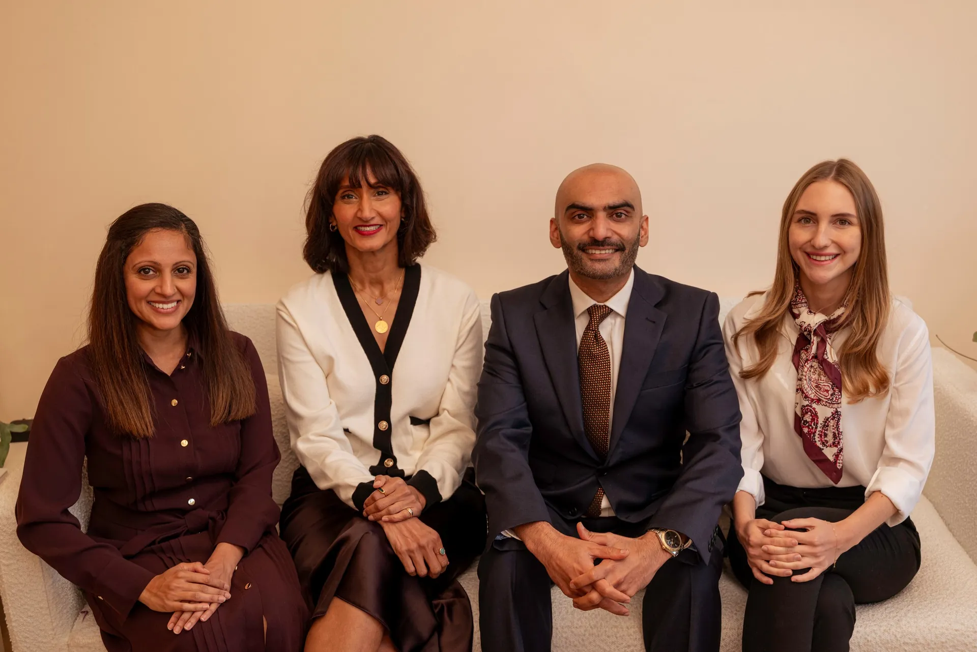 The Dental & Wellness London team seated together in the clinic lounge — the tooth-body connection