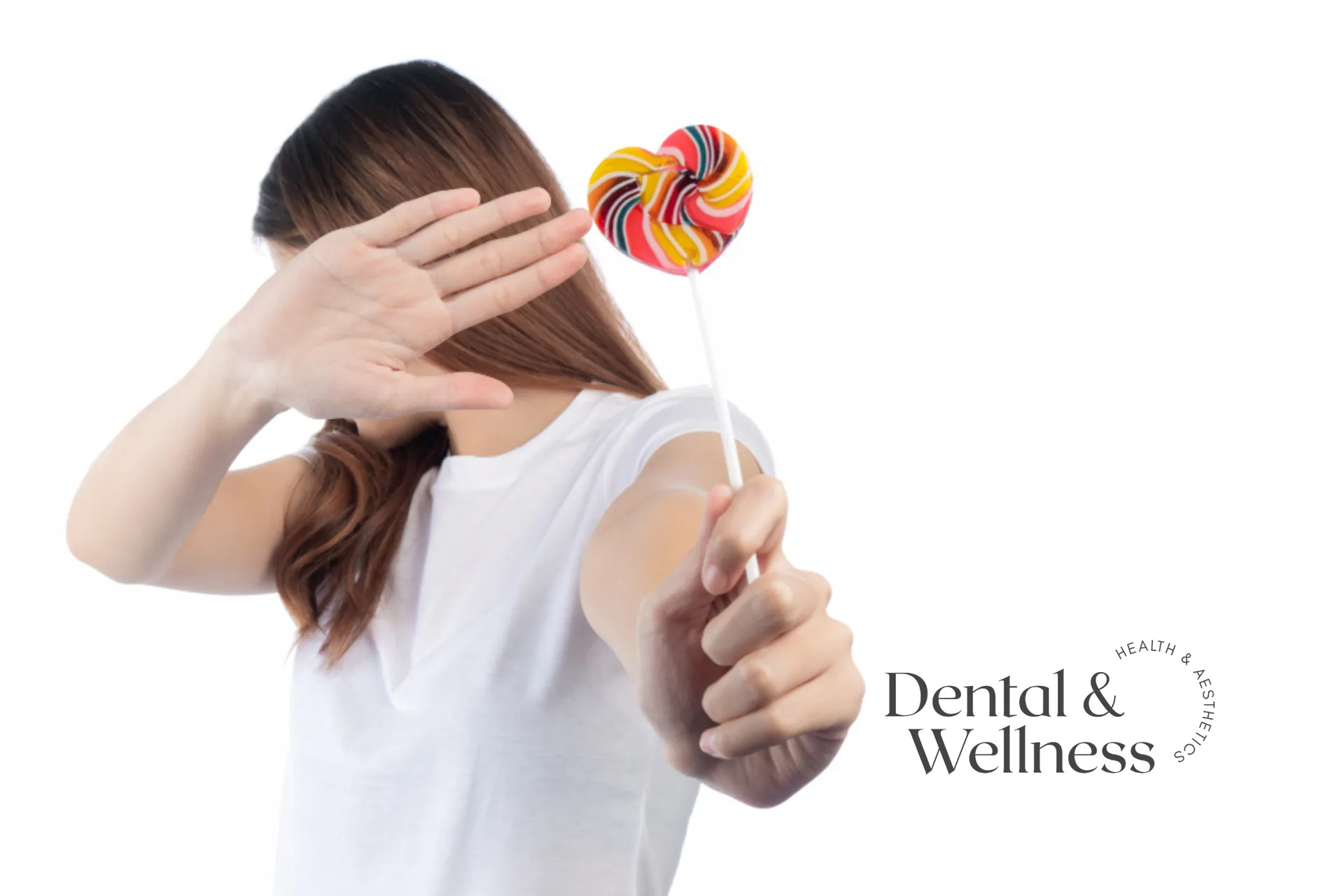 Woman turning away and refusing a lollipop — foods to eat after tooth extraction