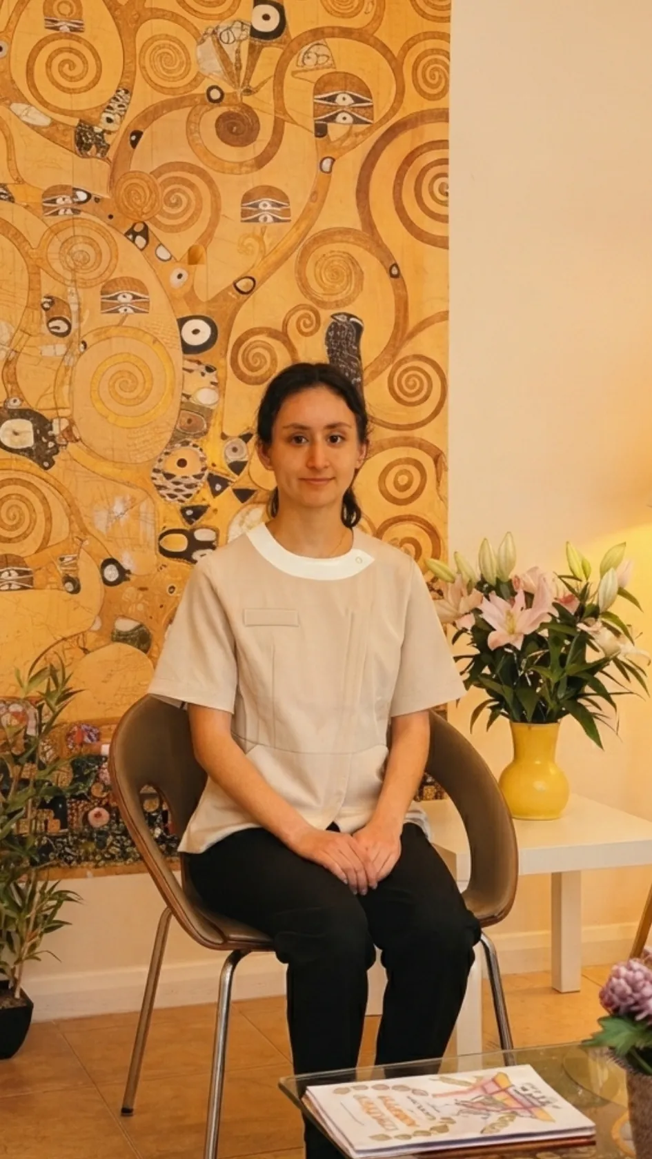 Michell Castillo, trainee dental nurse, seated in the lounge at Dental & Wellness London