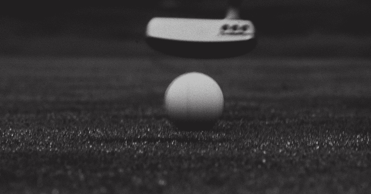 golf putting with ball rolling