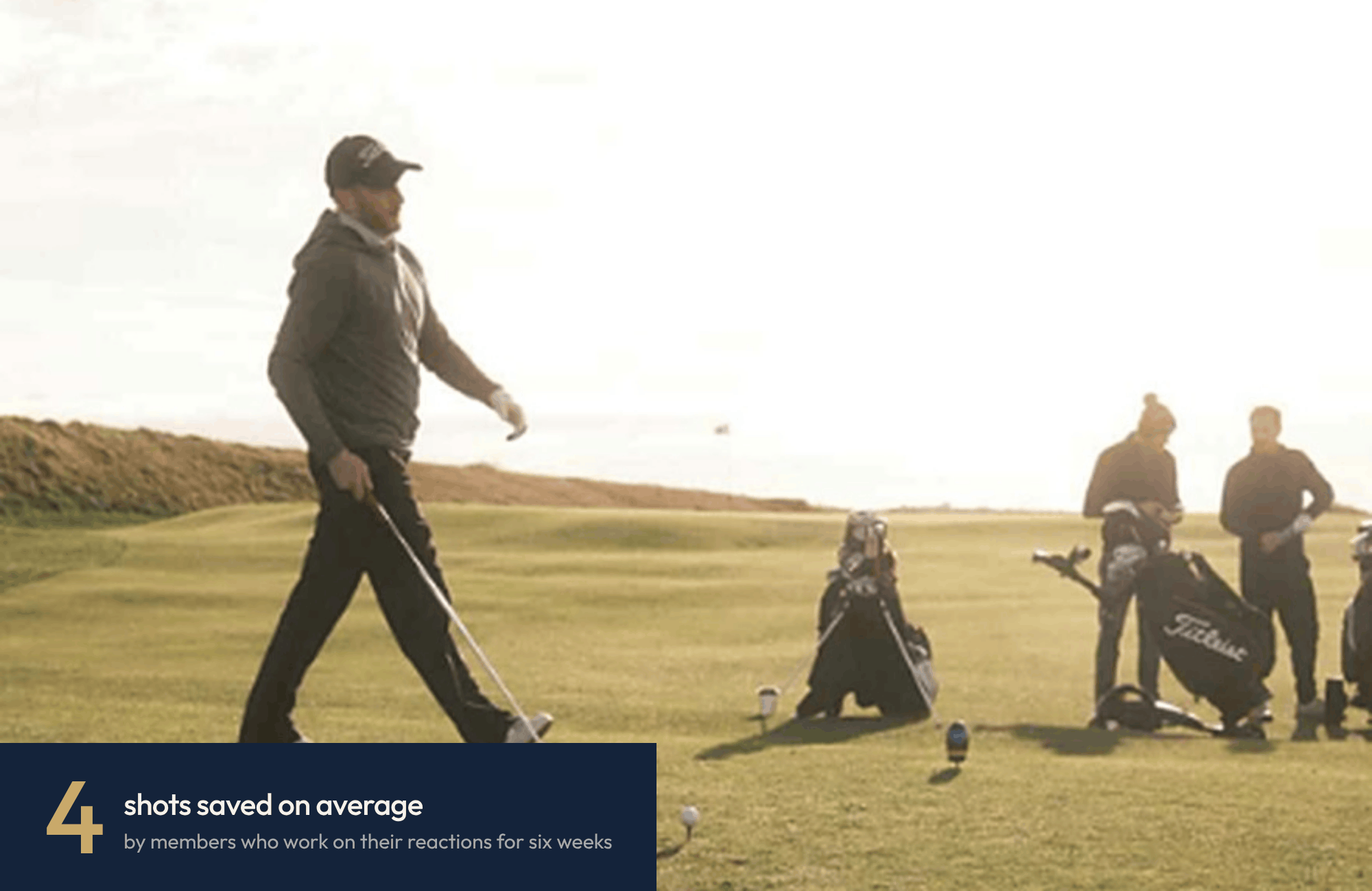 A golfer stepping up to hit his tee shot with a winter sun in the background