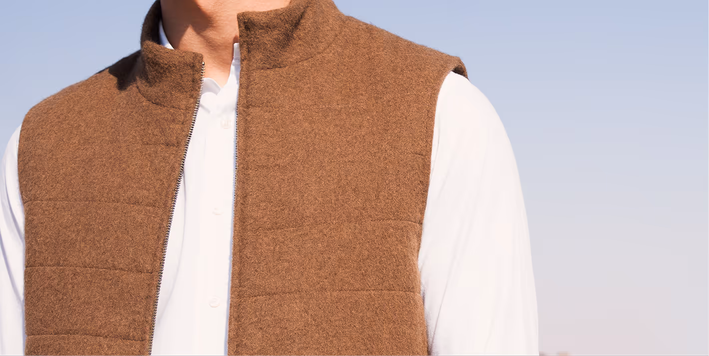 Model wearing a premium quilted vest made from sustainable NOUKK camel hair.