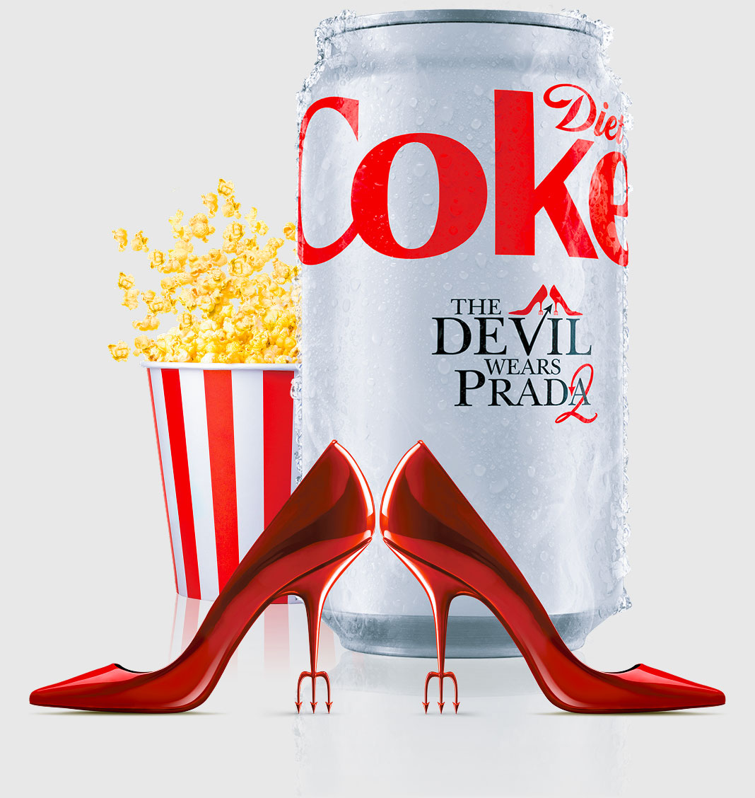 Diet Coke can with 'The Devil Wears Prada 2' text, red high heels with devil pitchfork heels, and a striped popcorn container with popcorn.