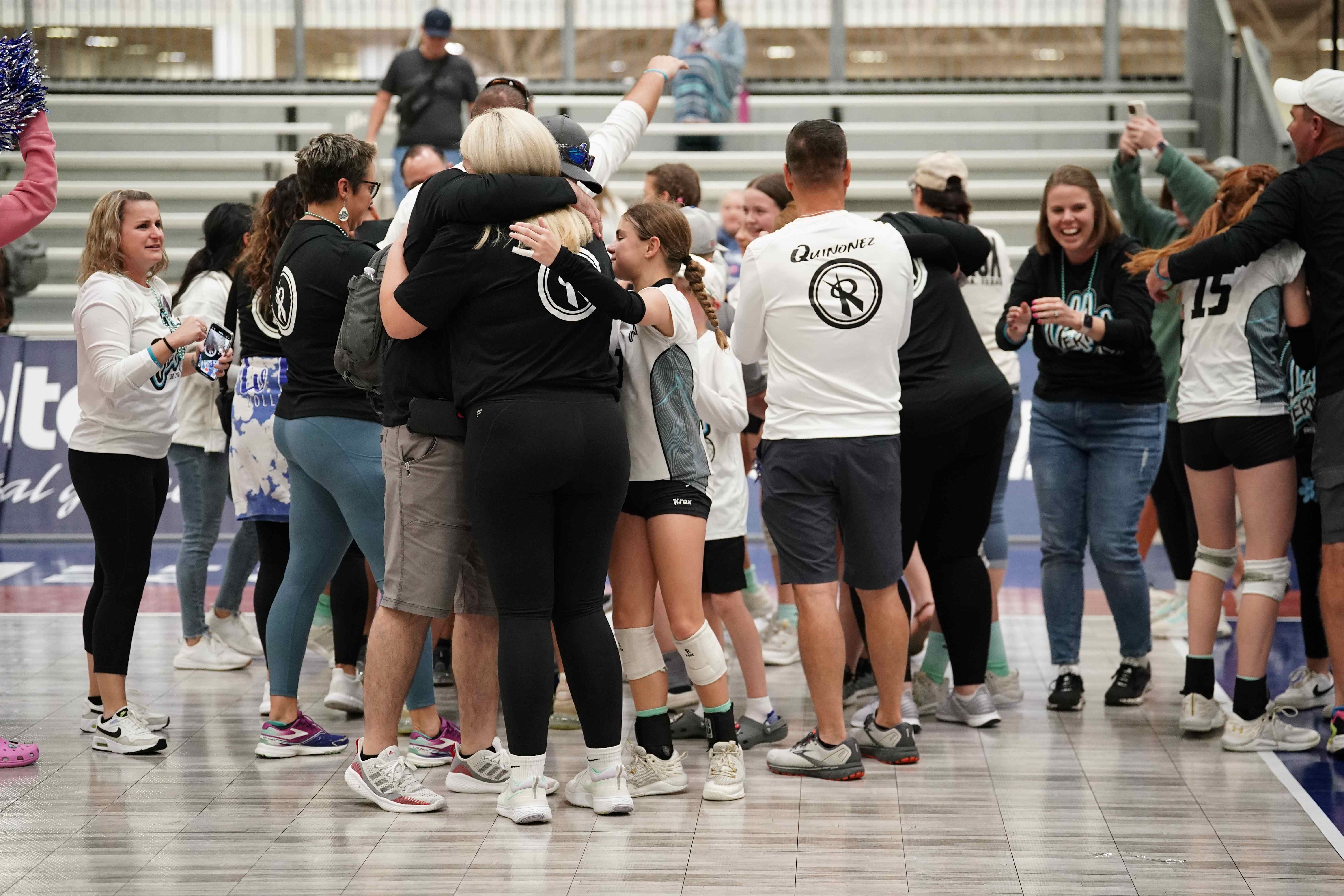 Players and families celebrating after winning a USAV National Championship