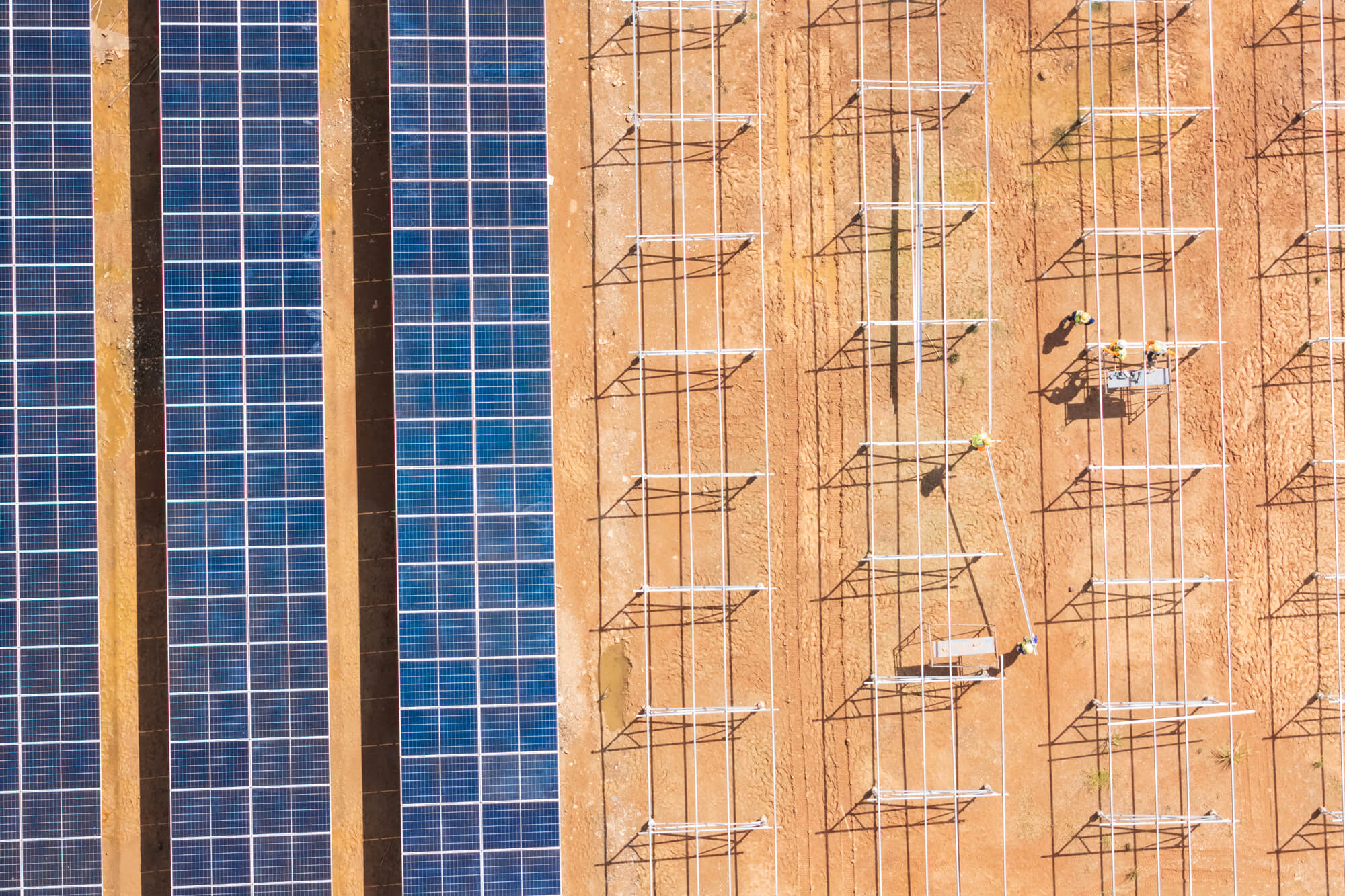 An aerial view of solar panels in a desert